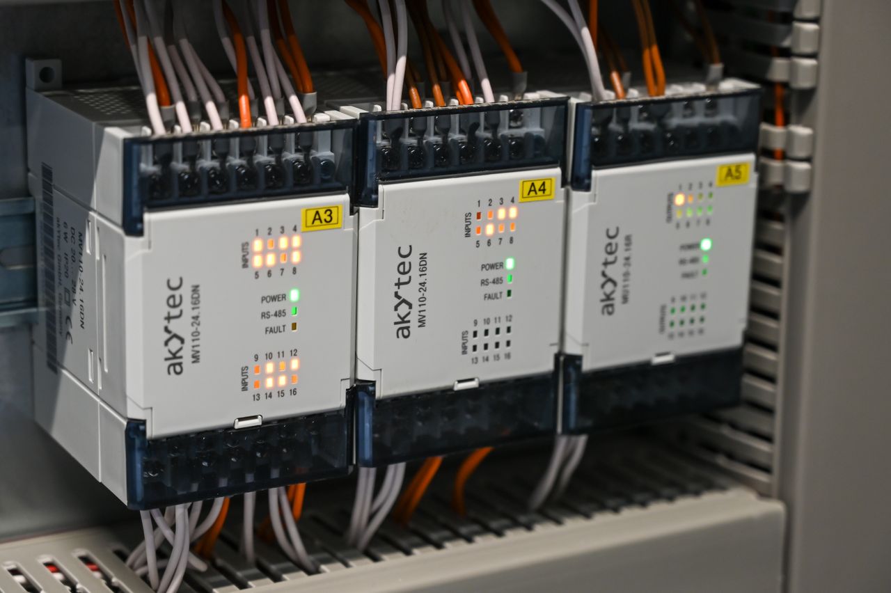 about-02 Close-up of industrial control boxes with wires and lights.