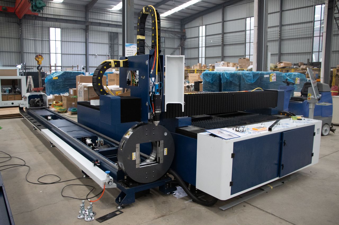 services-01 A large industrial laser cutter inside a warehouse in Jinan, China, showcasing advanced machinery.